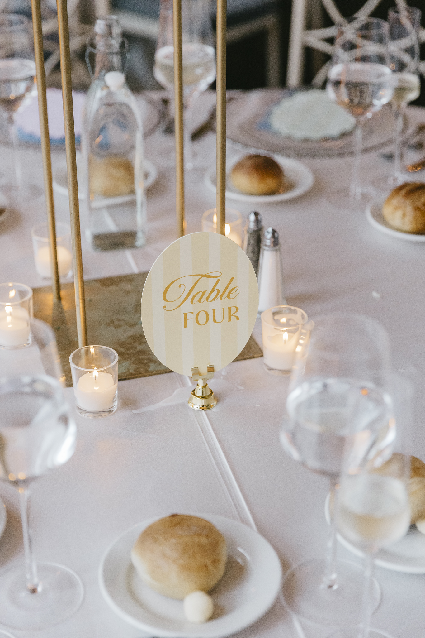 Rachel and Jeremy's reception table number and blue place setting