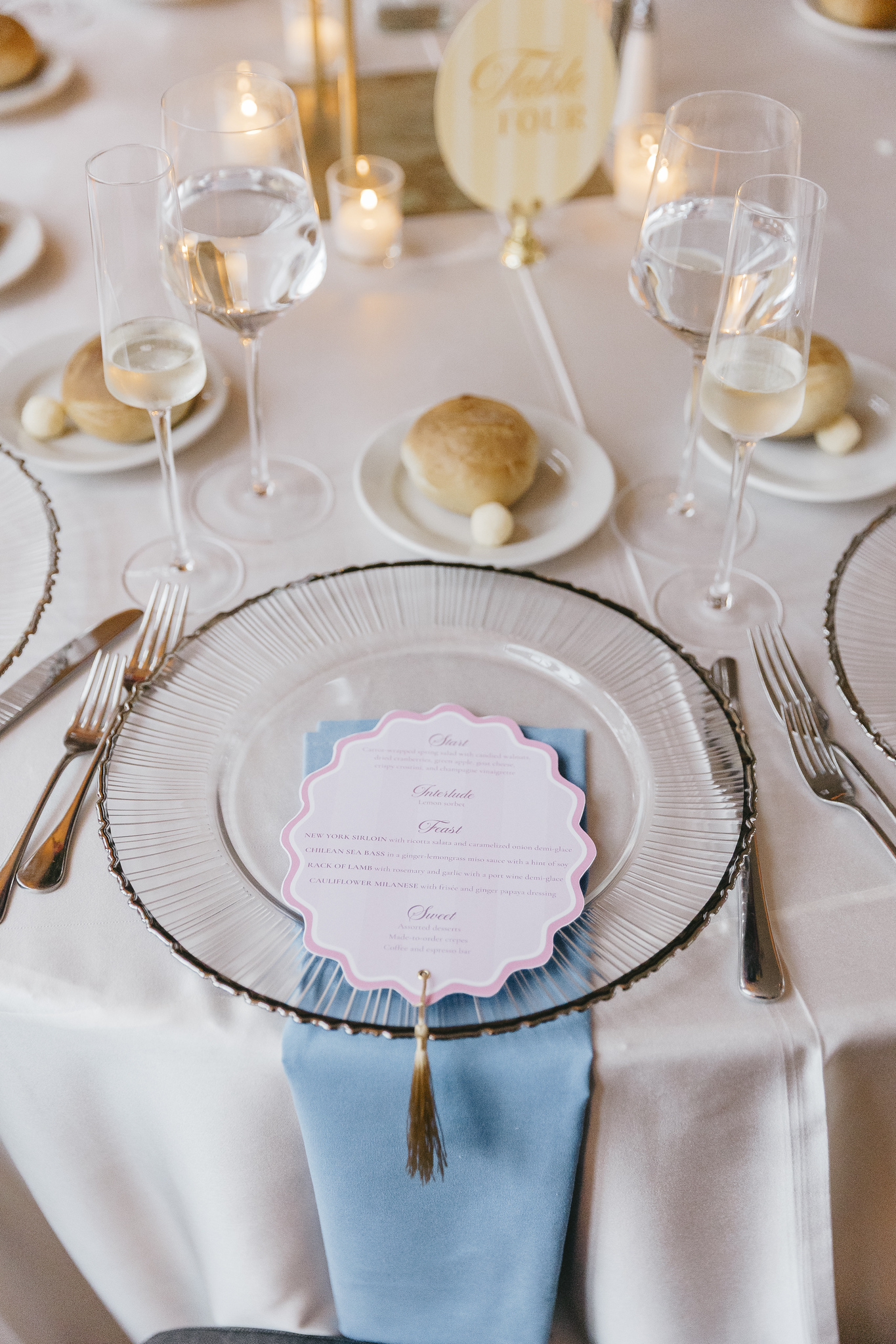Rachel and Jeremy's reception place setting with blue napkin and custom menu